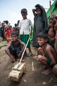 Grass hut village boys with toy